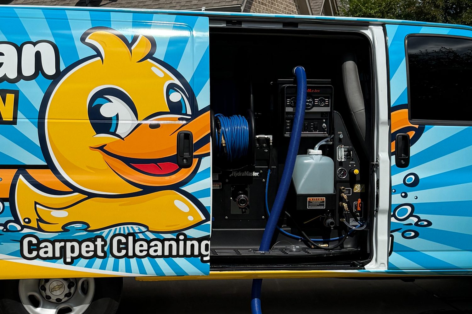 Squeaky Clean branded van with truck-mounted cleaning equipment
